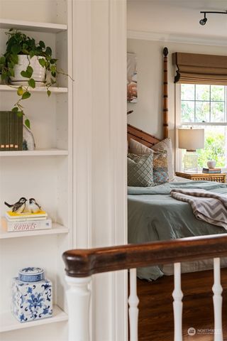 a bedroom with a bed and glass window