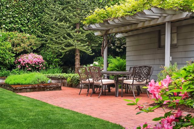 a view of backyard with plants and outdoor seating