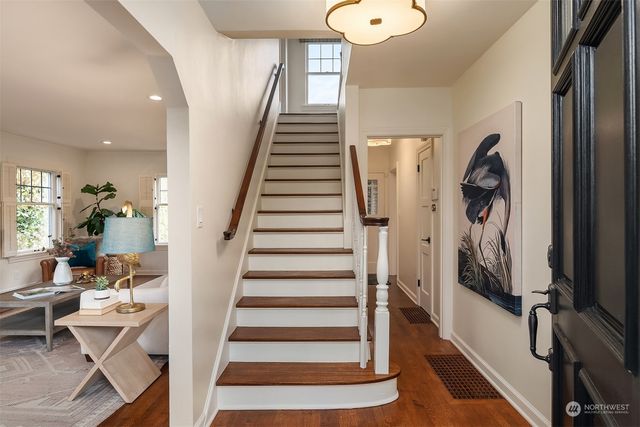 a view of entryway and hall with wooden floor