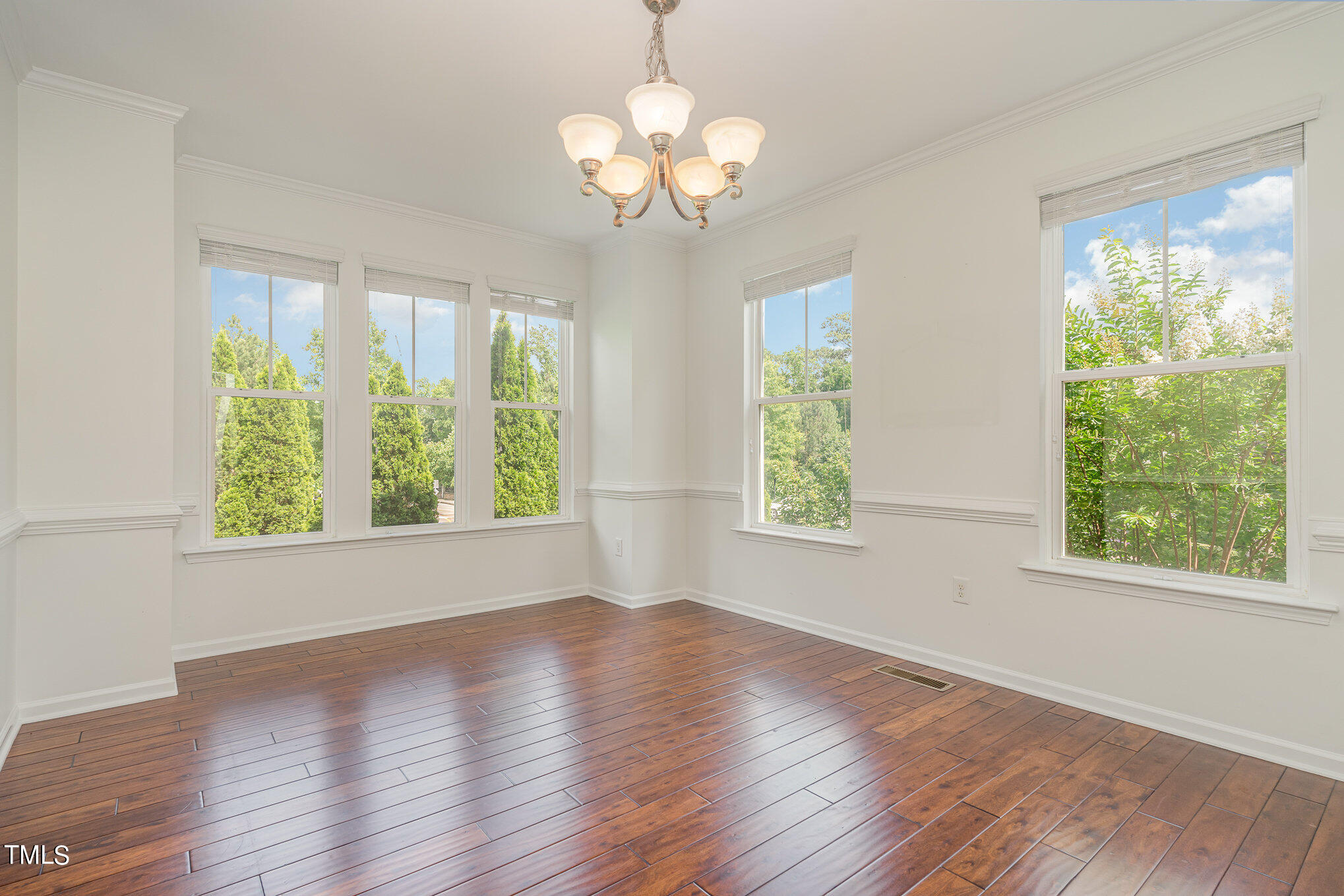 1435 Van Page Boulevard Raleigh, NC 27607 - Photo 15 of 41 a view of an empty room with wooden floor and a window