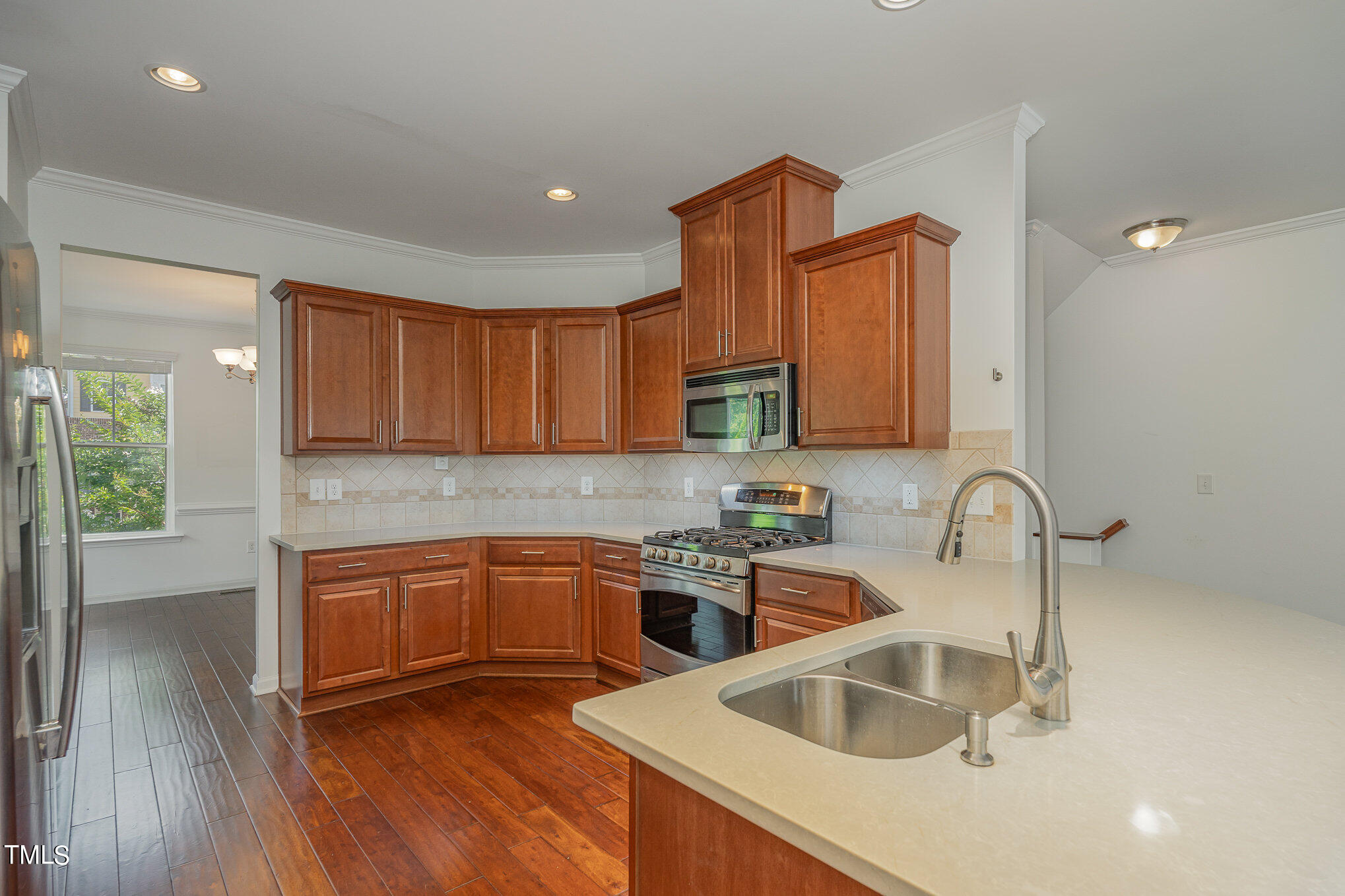 1435 Van Page Boulevard Raleigh, NC 27607 - Photo 17 of 41 a kitchen with stainless steel appliances granite countertop a sink stove and cabinets