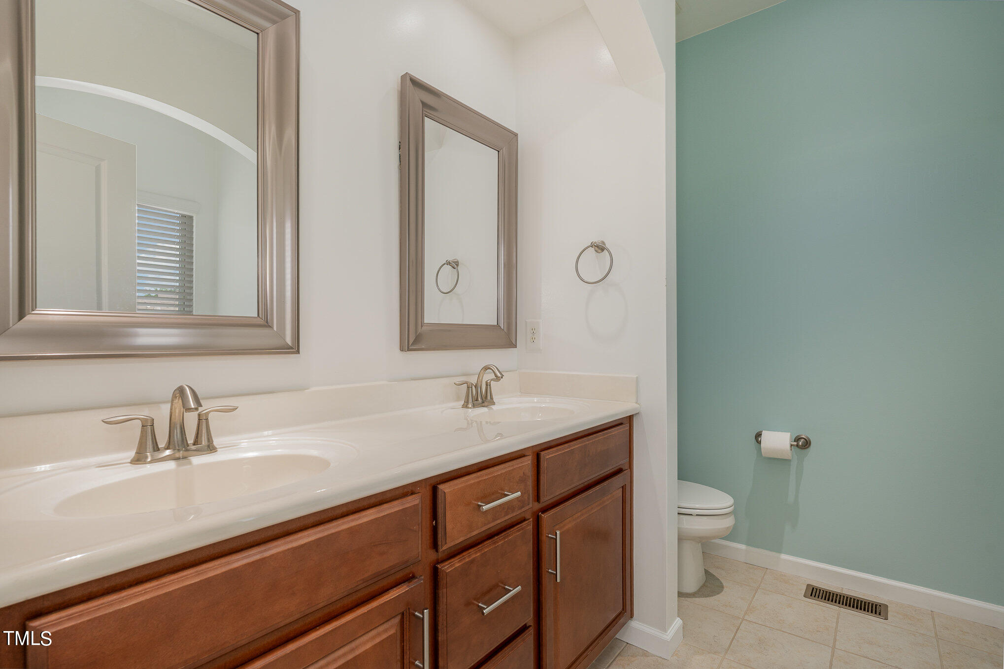 1435 Van Page Boulevard Raleigh, NC 27607 - Photo 28 of 41 a bathroom with a granite countertop sink and a mirror