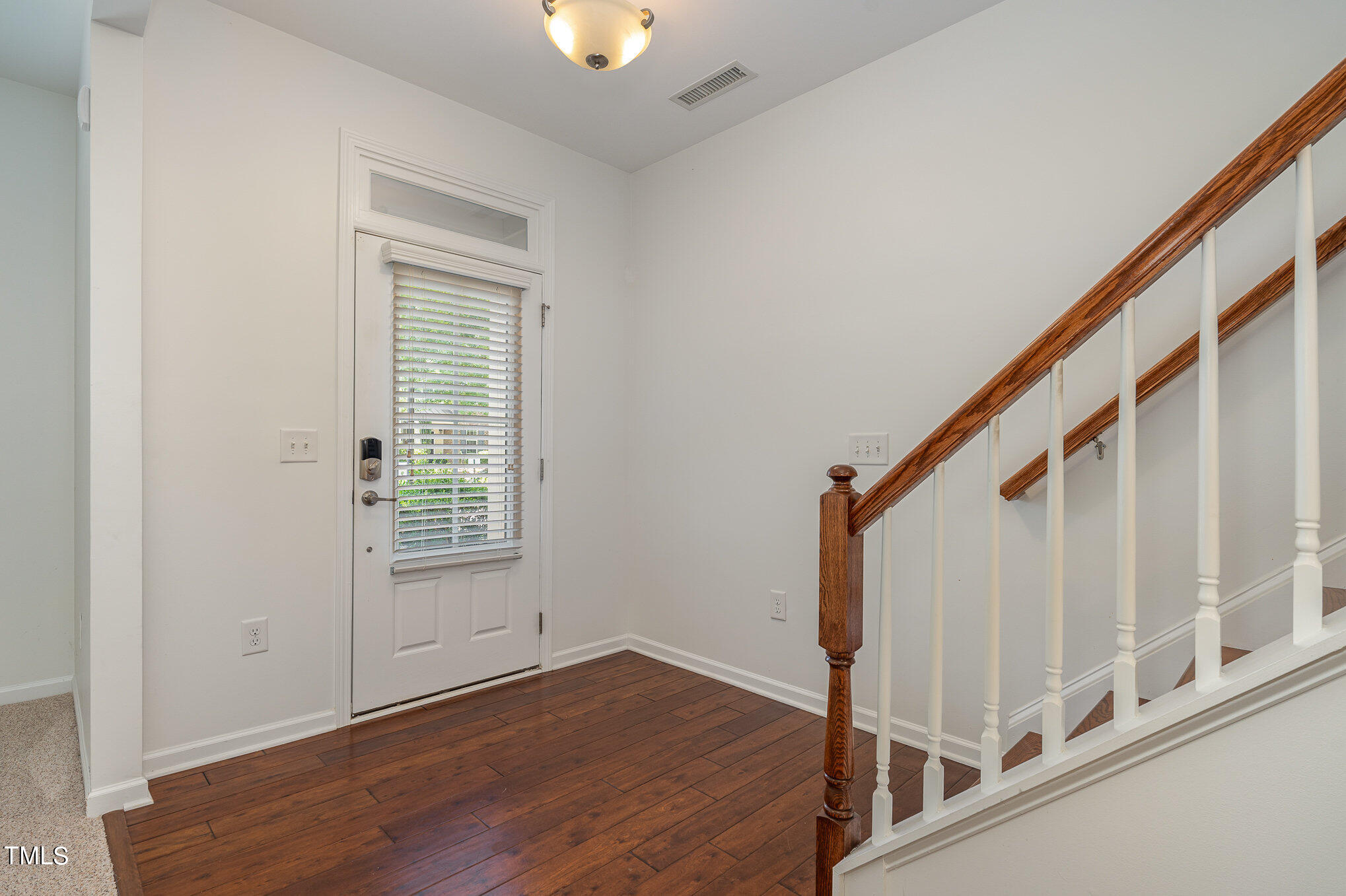 1435 Van Page Boulevard Raleigh, NC 27607 - Photo 10 of 41 a view of entryway with wooden floor and stairs