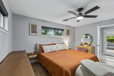 a bedroom with a bed and wooden floor