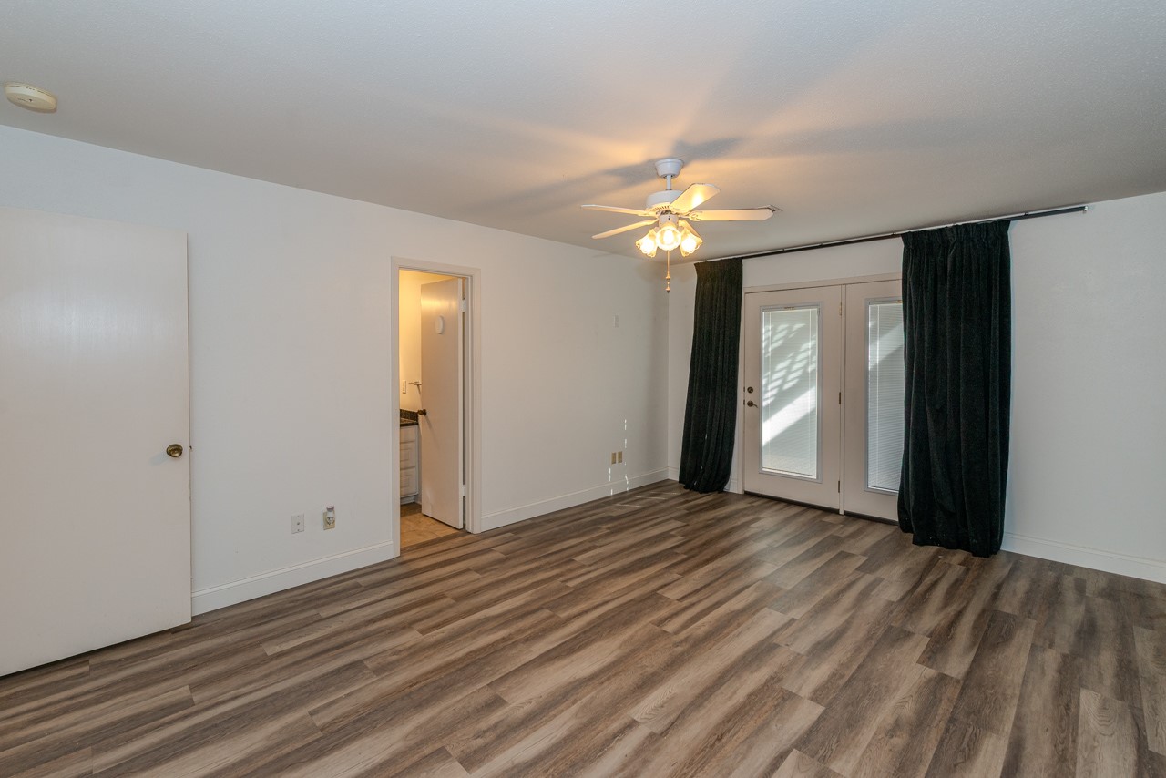 5975 Meadow Way Beaumont, TX 77707 - Photo 11 of 18 a view of an empty room with window chandelier fan and fire place