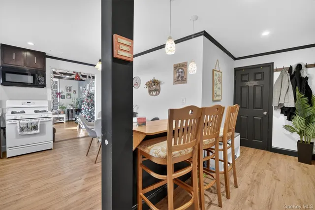 a dining room with furniture and wooden floor