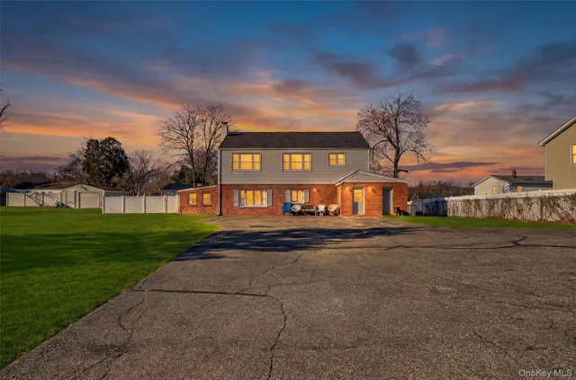 a view of a big house with a big yard