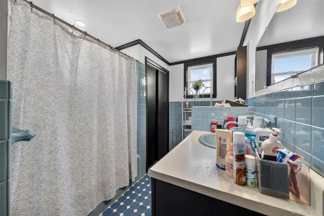 a bathroom with a sink vanity and a mirror