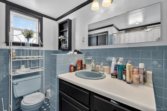 a bathroom with a sink a toilet and a mirror