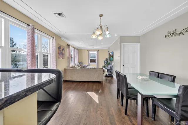 a view of a dining room with furniture and window