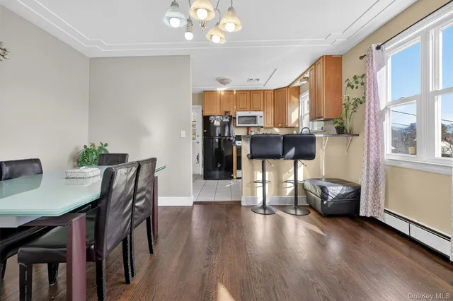 a view of a dining room with furniture and a chandelier