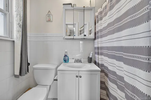 a bathroom with a sink a toilet and vanity