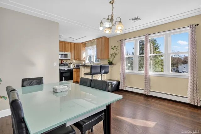 a view of a dining room with furniture window and wooden floor