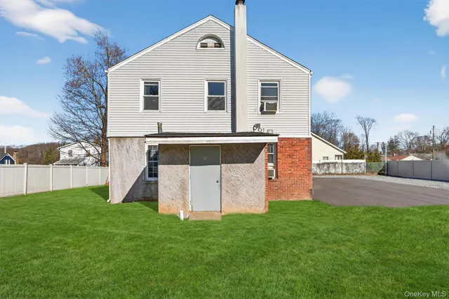 a front view of house with a garden