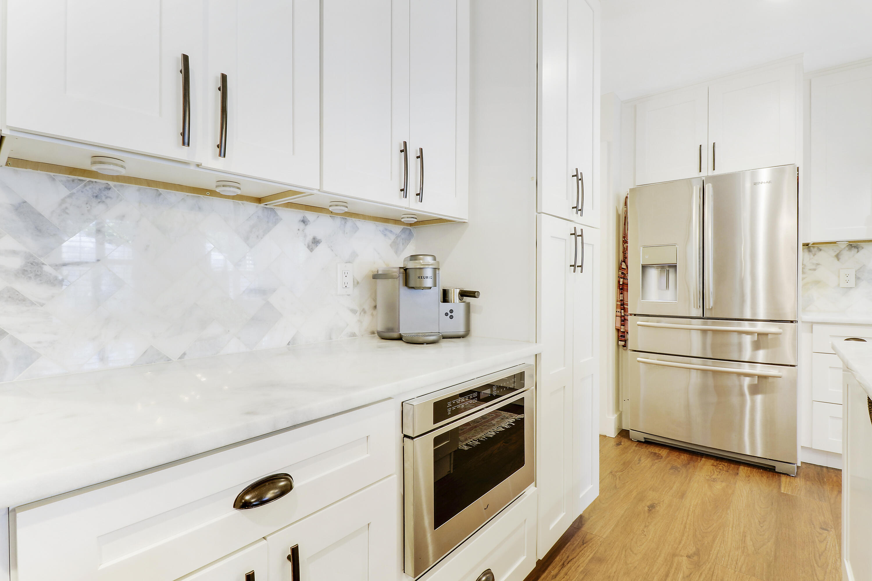 342 Country Club Drive Tequesta, FL 33469 - Photo 18 of 67 a kitchen with stainless steel appliances a refrigerator sink and cabinets