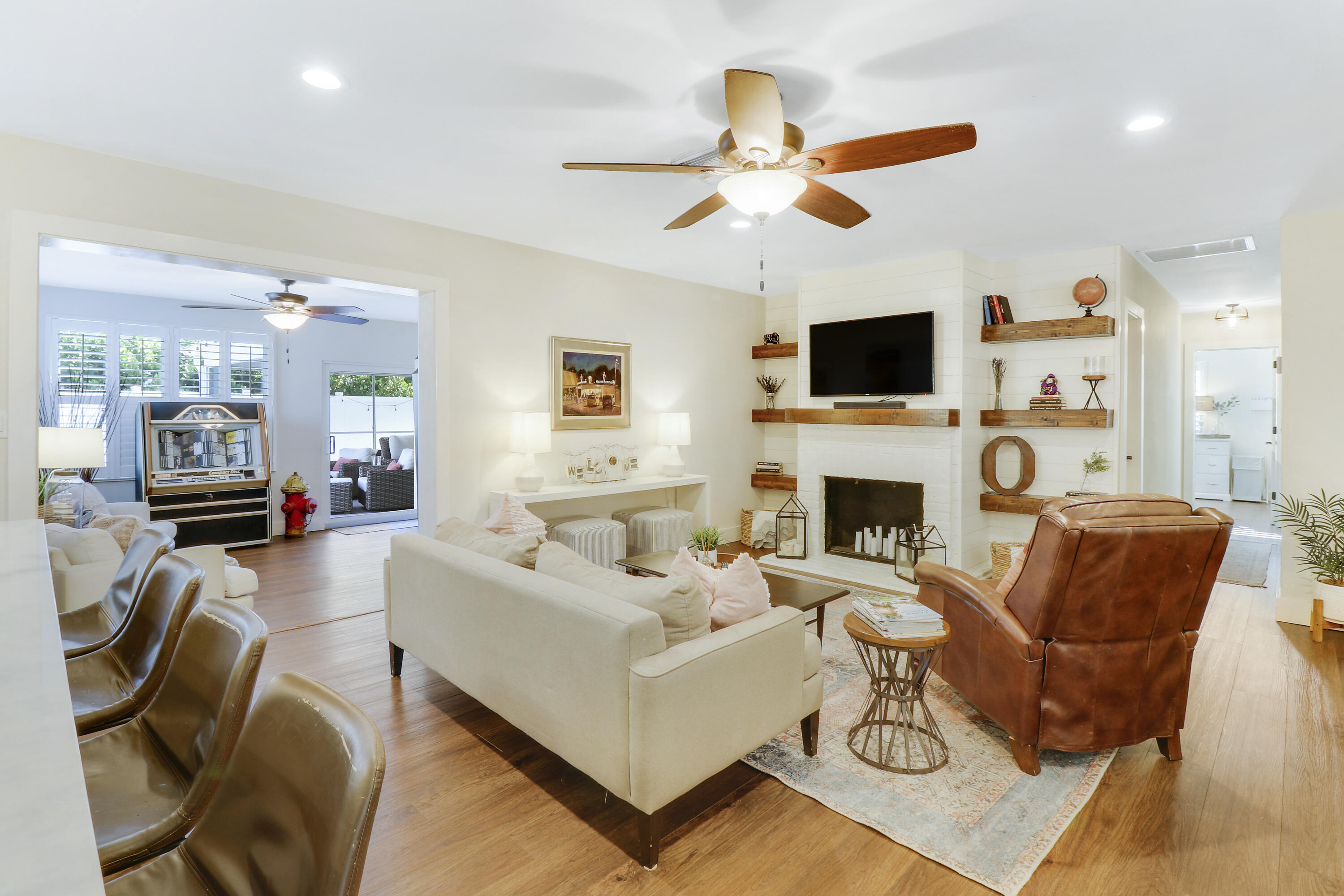 342 Country Club Drive Tequesta, FL 33469 - Photo 22 of 67 a living room with furniture a fireplace and a flat screen tv