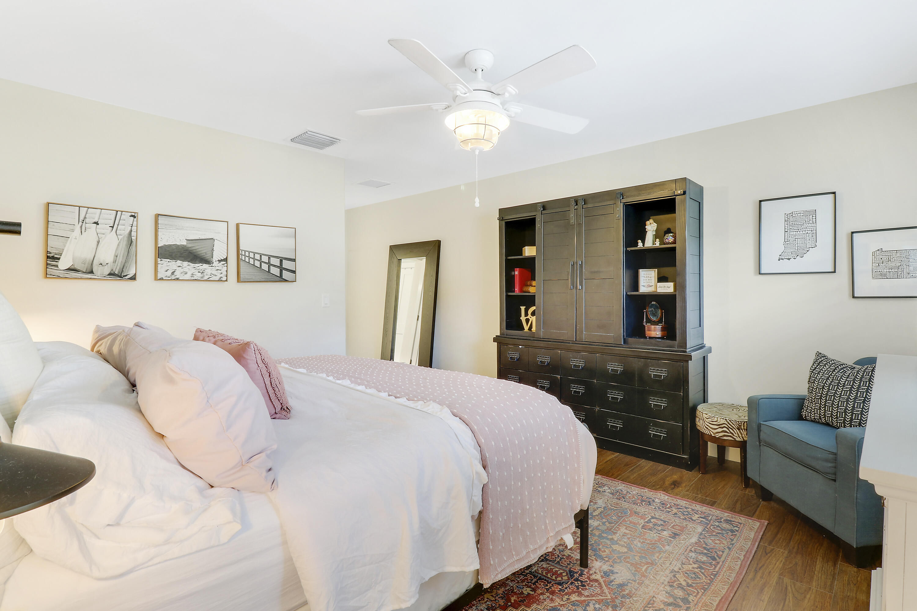 342 Country Club Drive Tequesta, FL 33469 - Photo 30 of 67 a bedroom with a bed and wooden floor