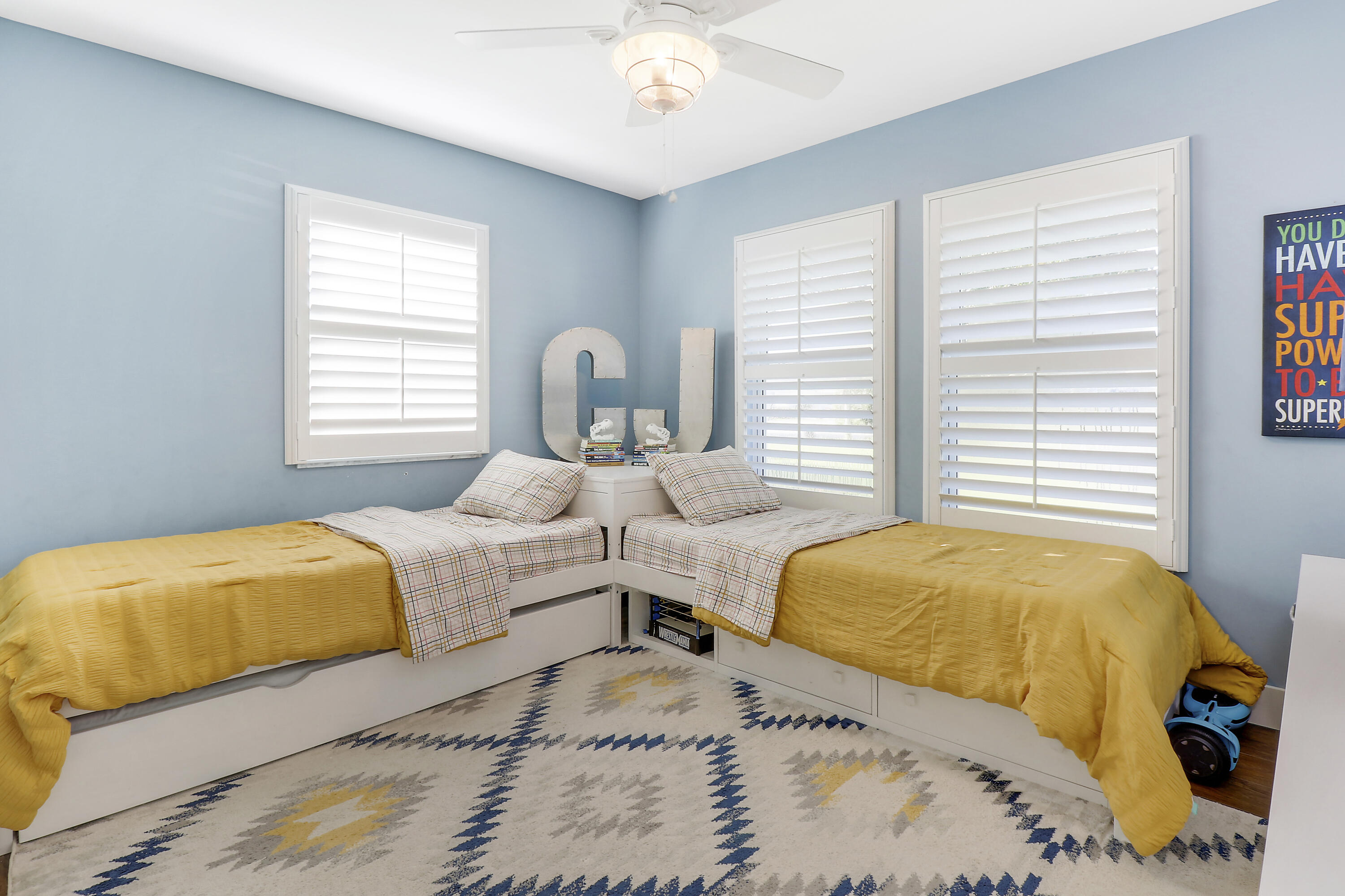 342 Country Club Drive Tequesta, FL 33469 - Photo 36 of 67 a bedroom with two beds and a chandelier