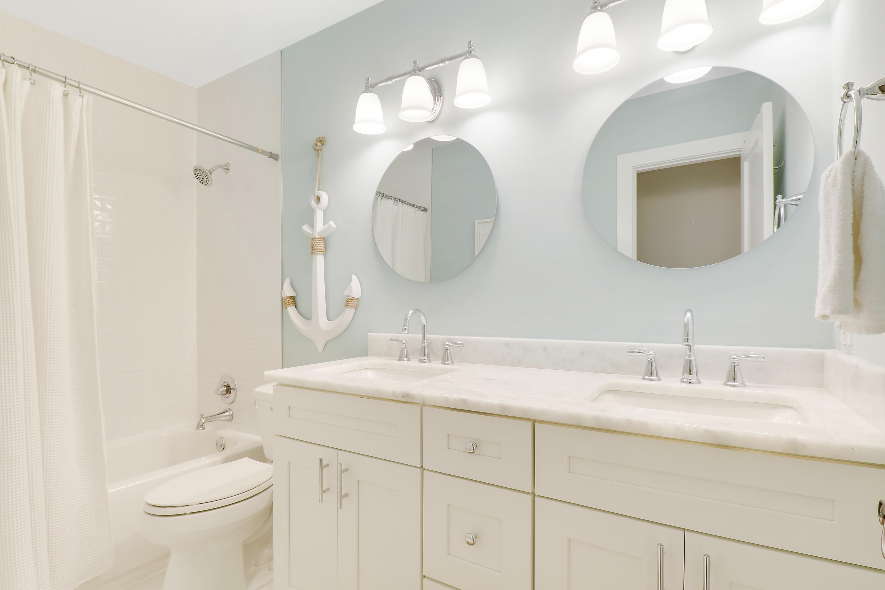 342 Country Club Drive Tequesta, FL 33469 - Photo 39 of 67 a bathroom with a double vanity sink and a mirror