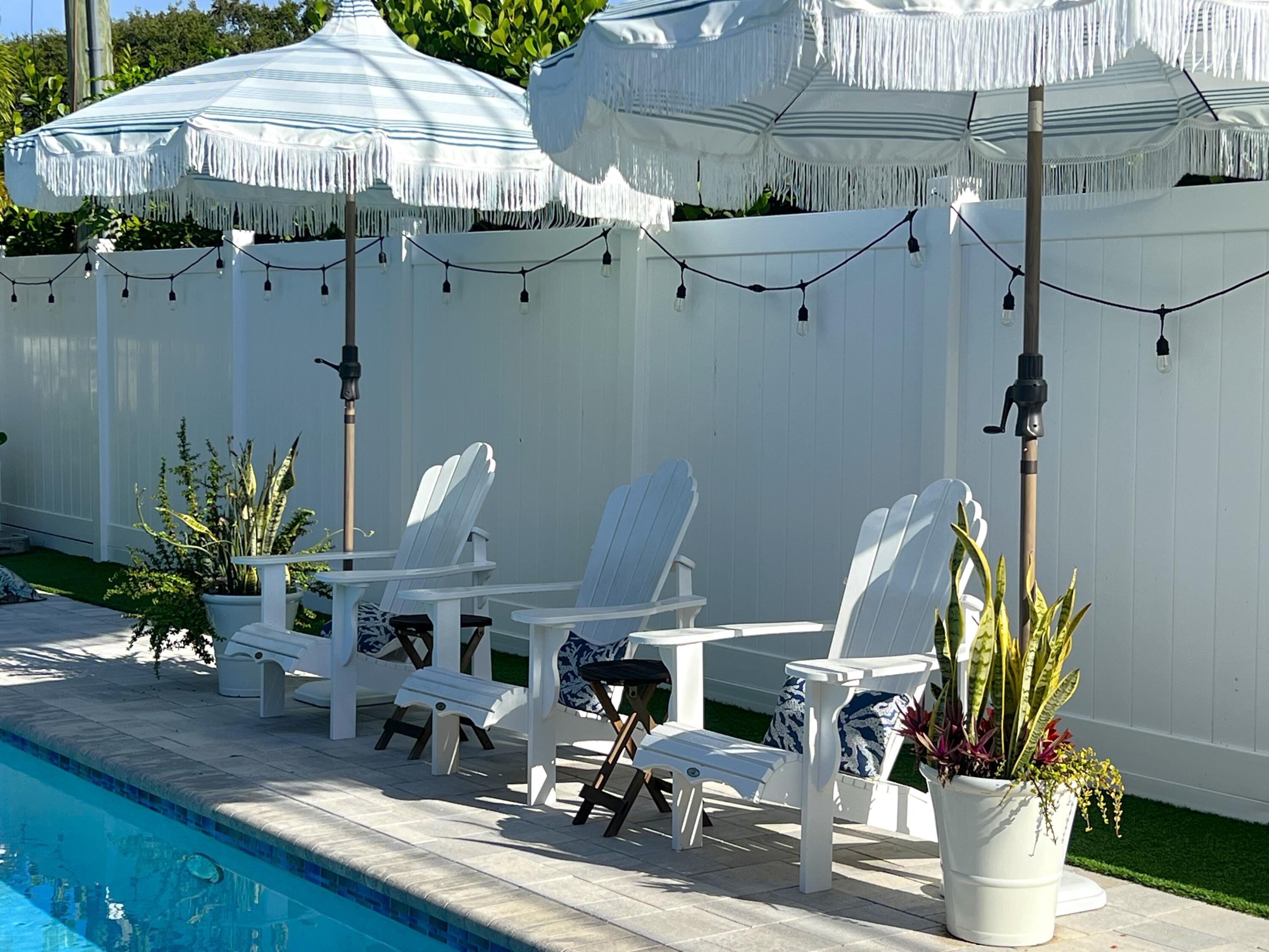 342 Country Club Drive Tequesta, FL 33469 - Photo 47 of 67 a view of a house with backyard water fountain and sitting area