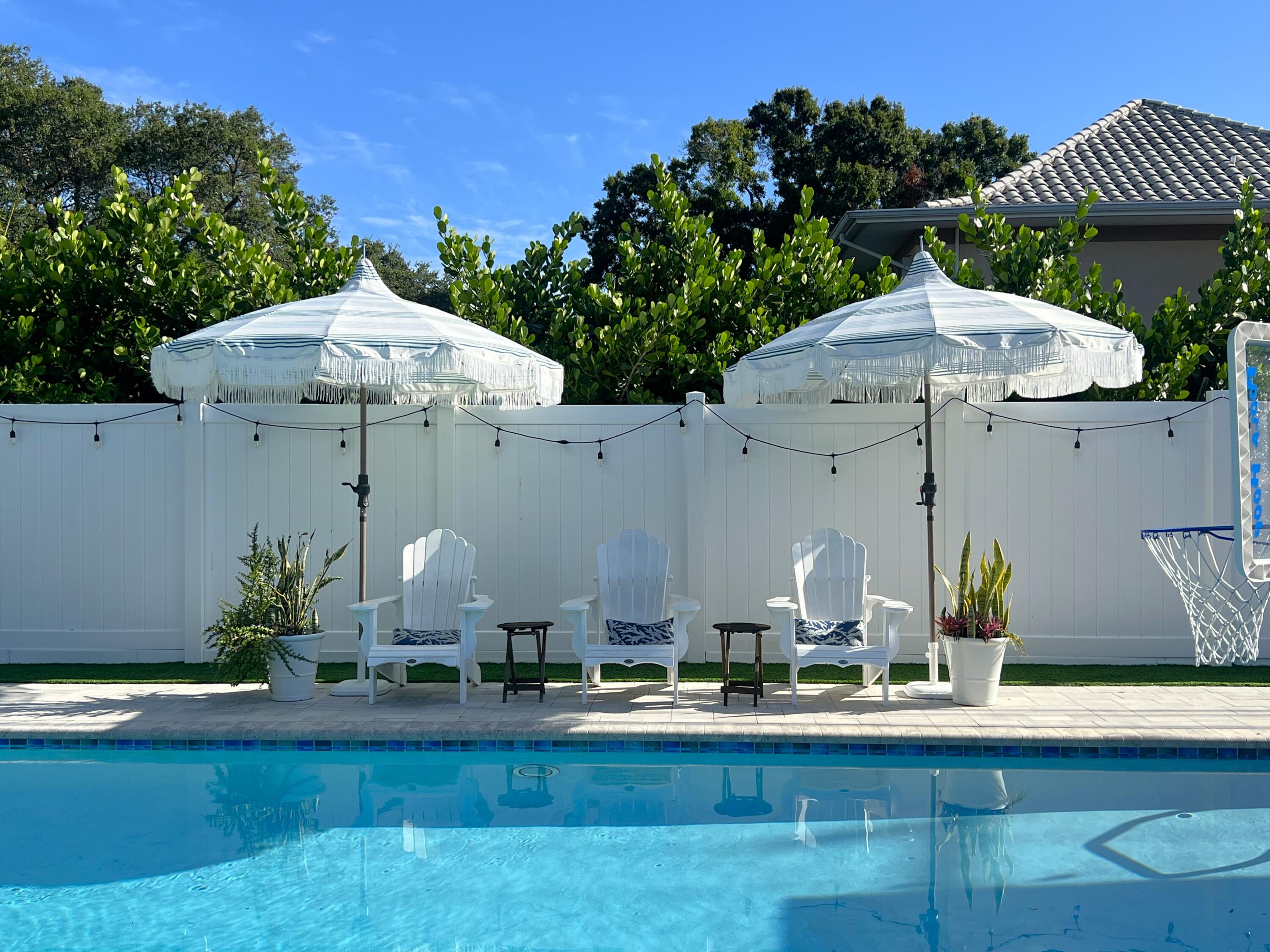 342 Country Club Drive Tequesta, FL 33469 - Photo 49 of 67 a front view of a house with garden