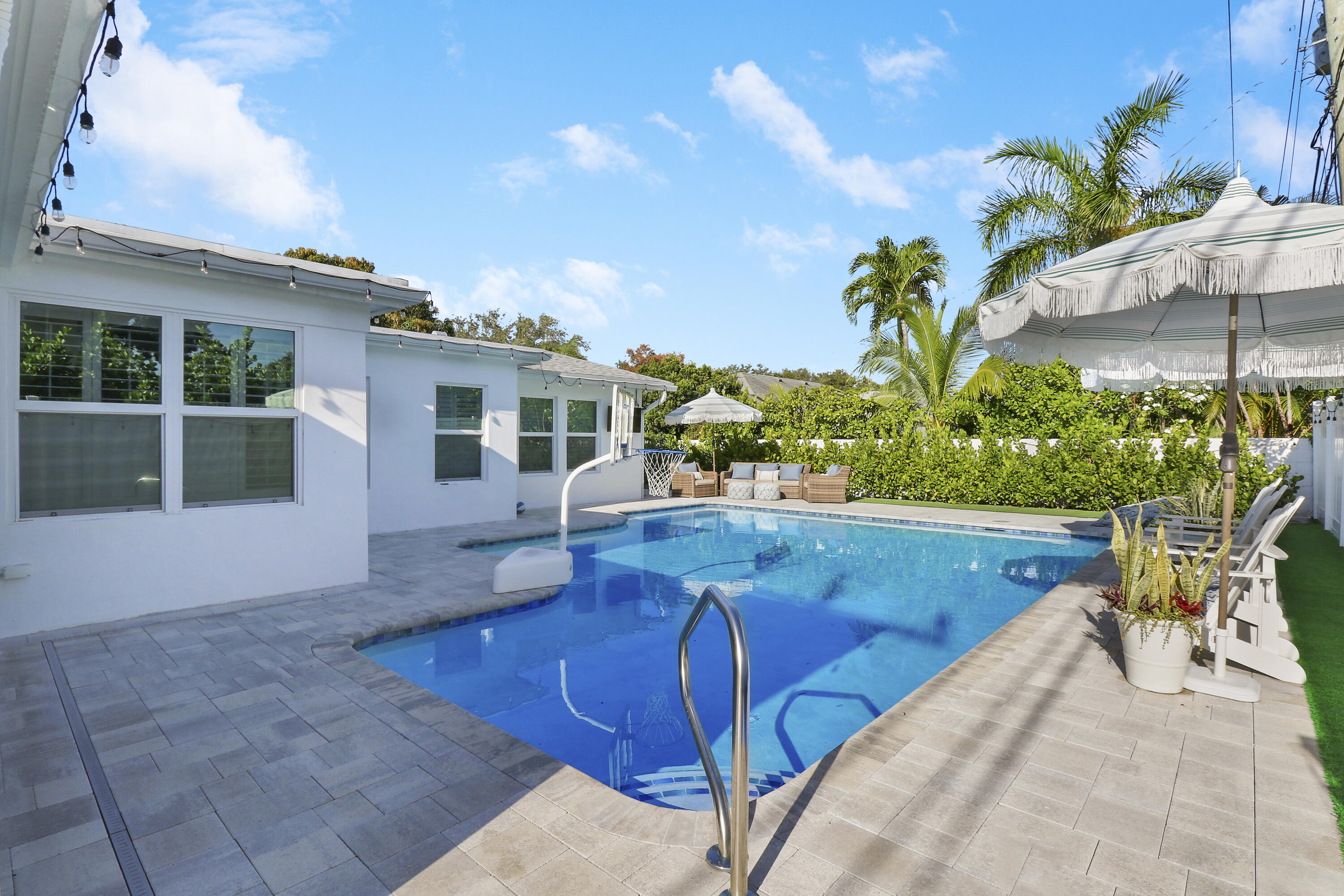 342 Country Club Drive Tequesta, FL 33469 - Photo 50 of 67 a view of a swimming pool with a patio