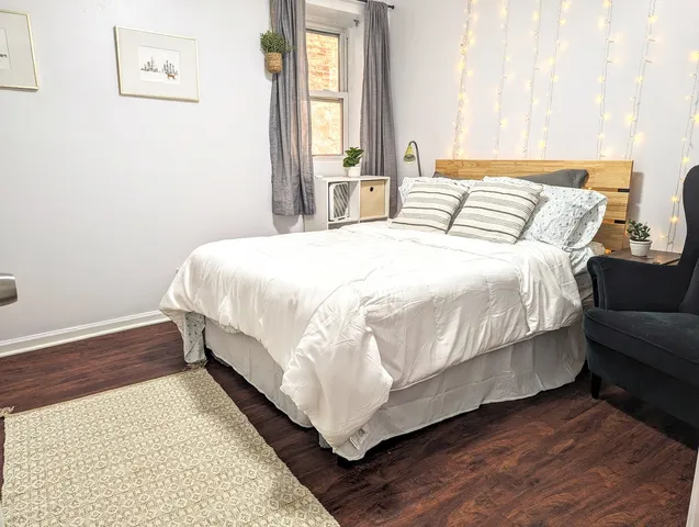 a bedroom with a bed and a window