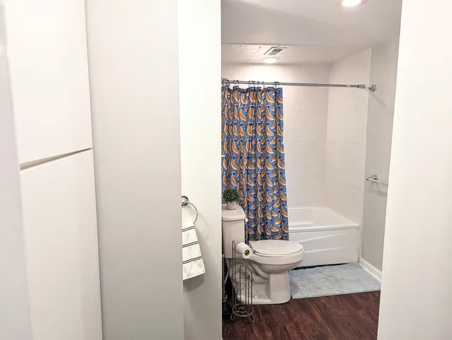 a bathroom with a toilet and a shower curtain