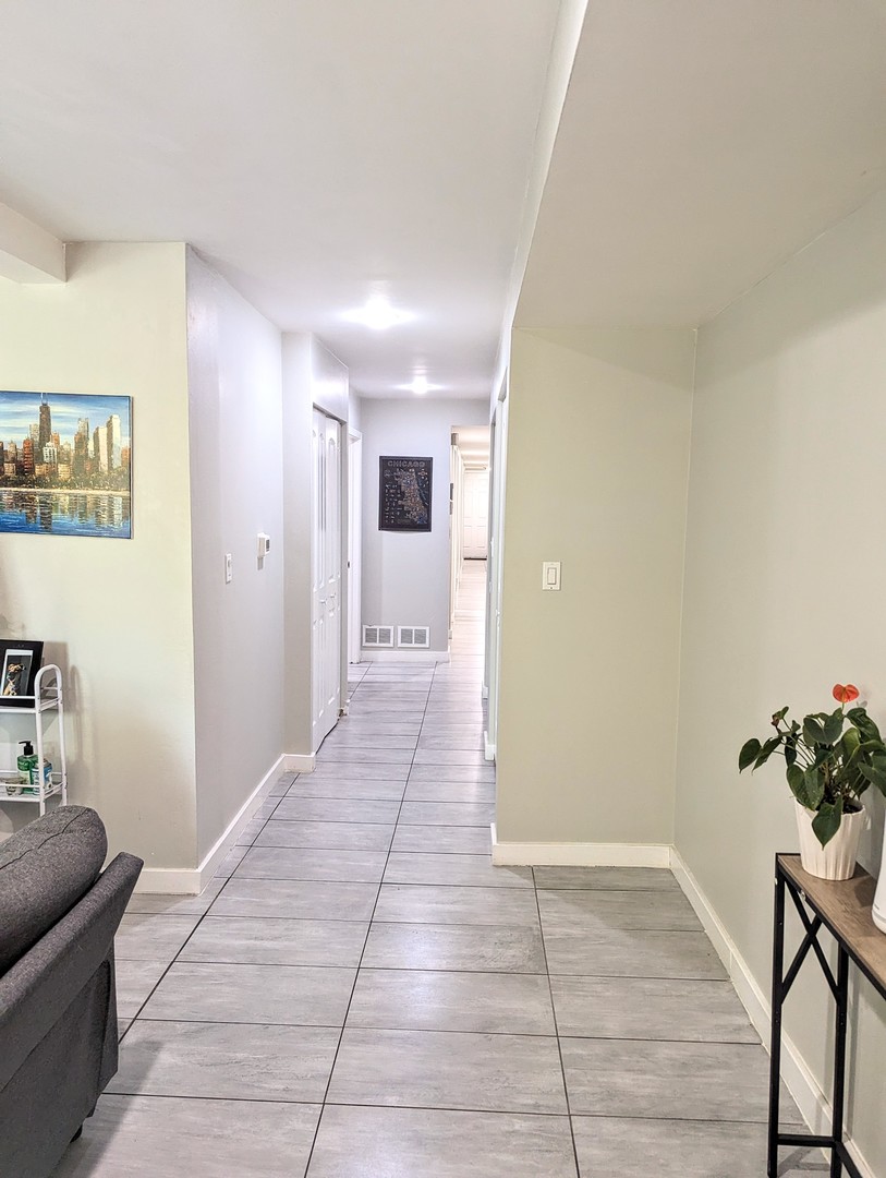 724 South Oakley Boulevard, Unit 1 Chicago, IL 60612 - Photo 8 of 22 a view of hallway with furniture and wooden floor