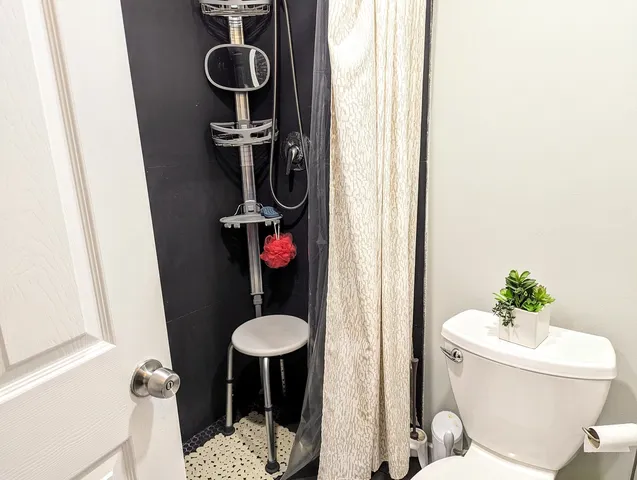 a bathroom with a sink toilet and a mirror