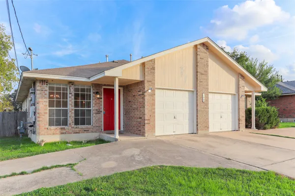 a view of a house with a yard and plants