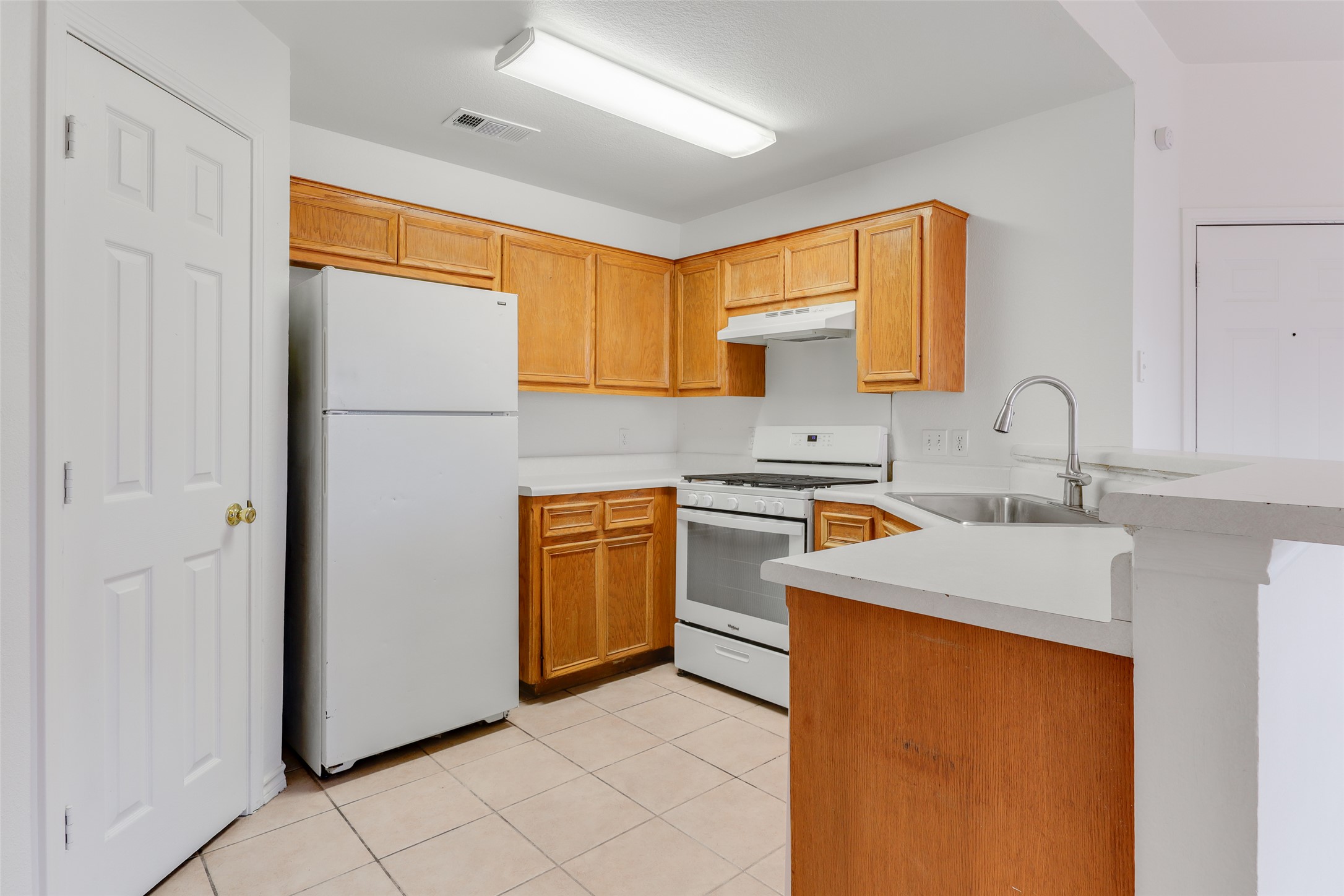 300 Tamara Drive, Unit A Georgetown, TX 78628 - Photo 6 of 12 a kitchen with stainless steel appliances granite countertop a sink stove and refrigerator