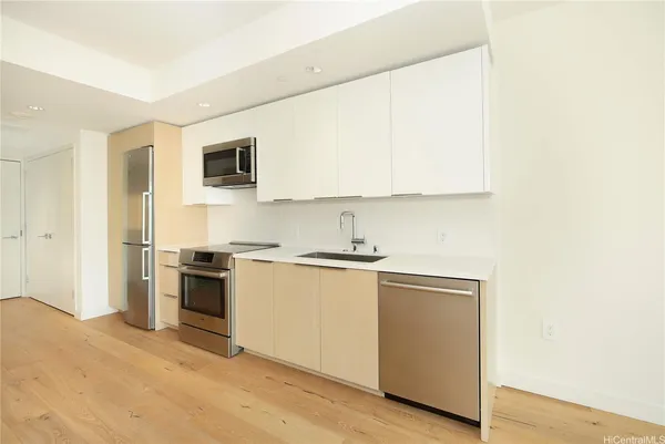 a kitchen with a sink and a stove top oven