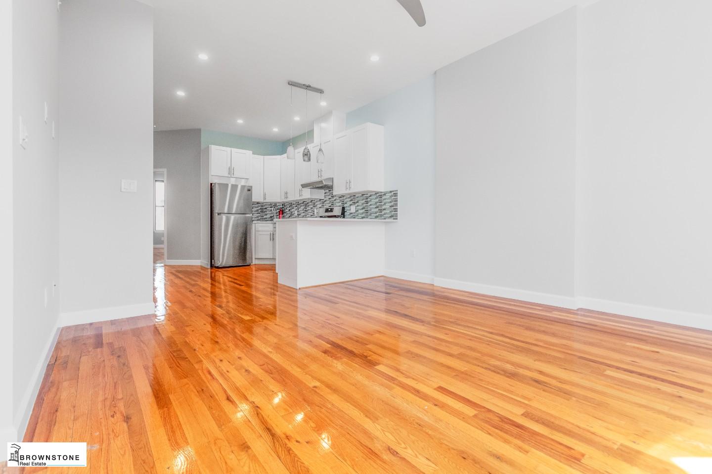 459 77th Street, Unit 3 Brooklyn, NY 11209 - Photo 3 of 9 a view of kitchen and empty room with wooden floor