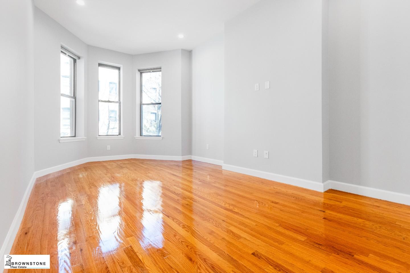459 77th Street, Unit 3 Brooklyn, NY 11209 - Photo 5 of 9 an empty room with wooden floor and windows