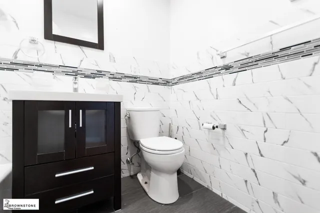 a bathroom with a sink a toilet and a mirror