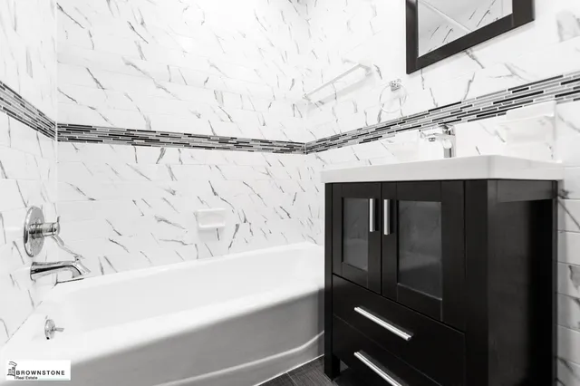 a bathroom with a bathtub and shower