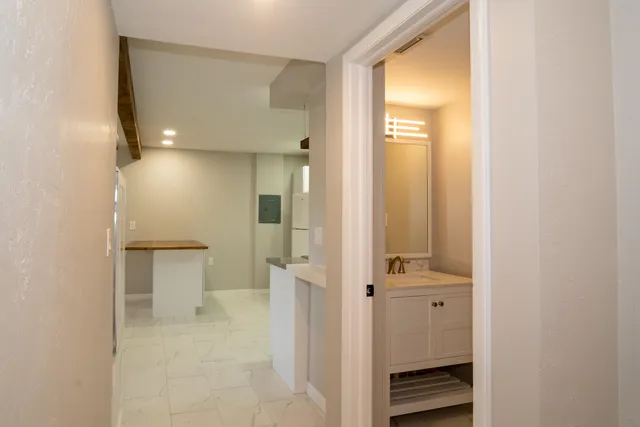 a view of a kitchen with a sink and refrigerator