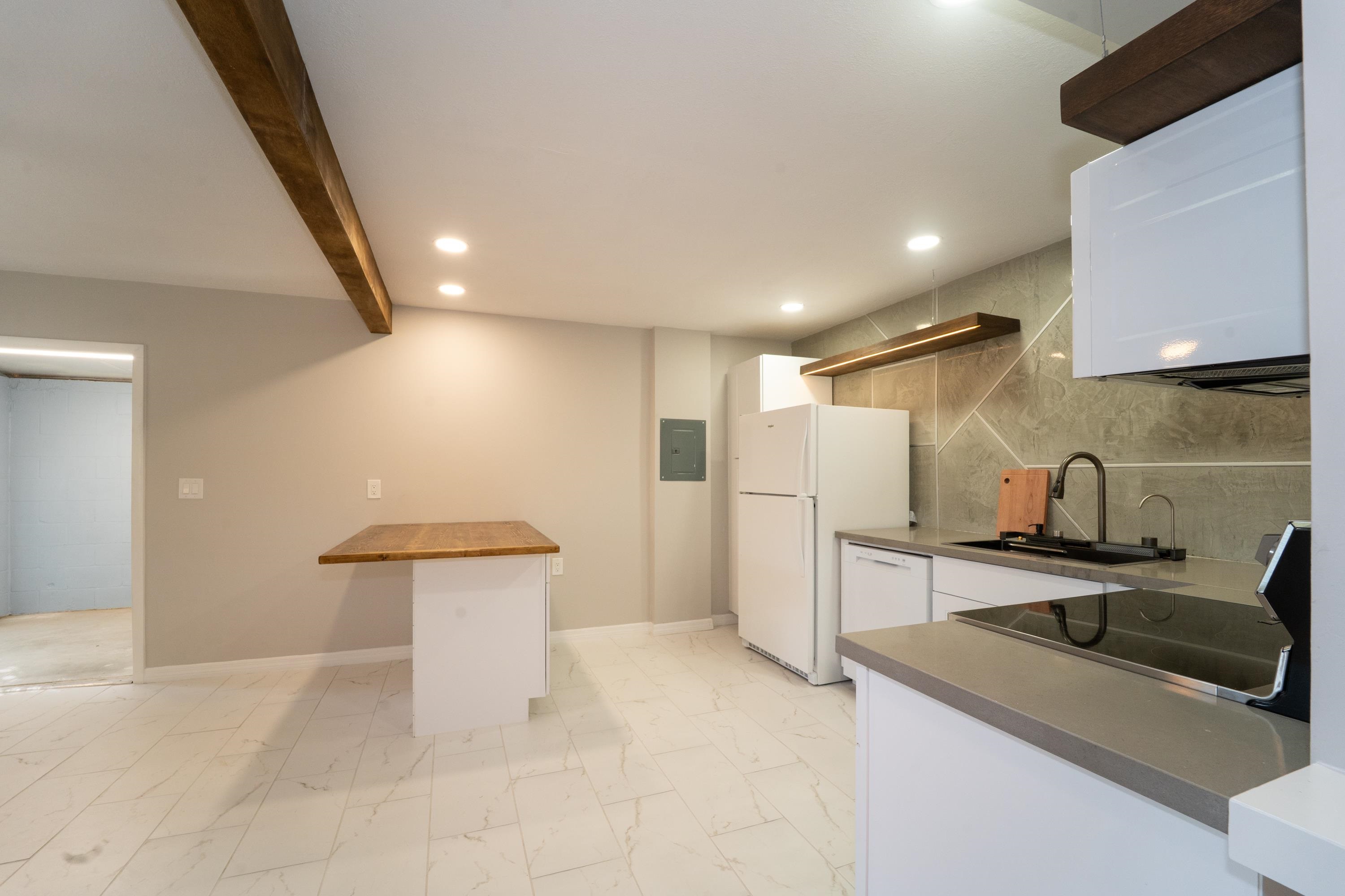 5455 Pelican Way, Unit B St. Augustine, FL 32080 - Photo 16 of 27 a view of a kitchen with a sink and refrigerator