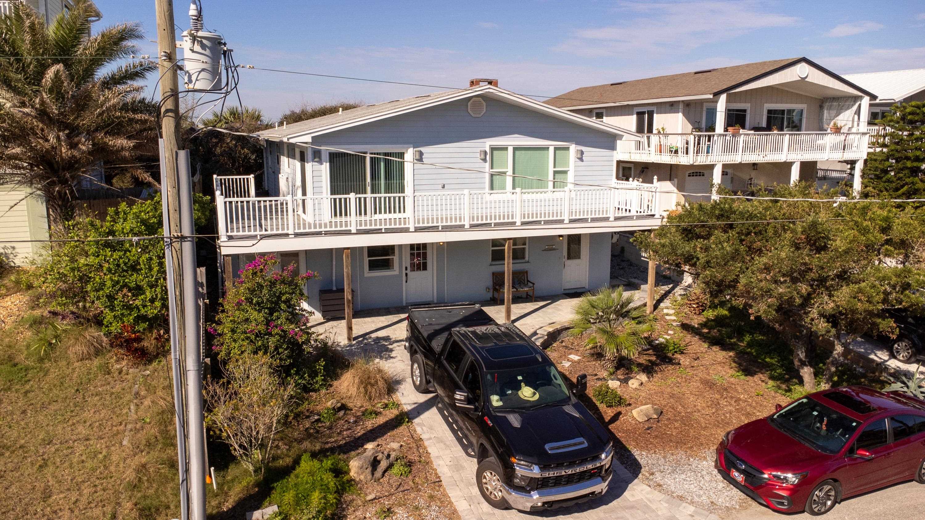 5455 Pelican Way, Unit B St. Augustine, FL 32080 - Photo 4 of 27 a view of a house with a patio and a yard