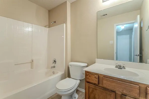 a bathroom with a sink toilet vanity and shower