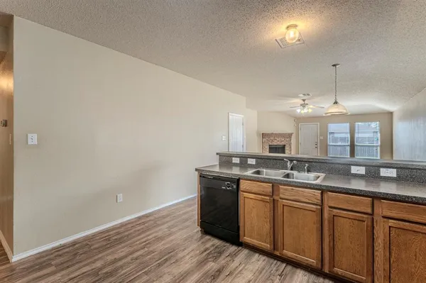 a kitchen with granite countertop a sink and cabinets