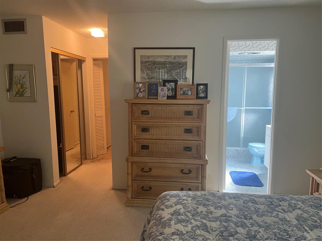 1425 Atlantic Shores Boulevard, Unit 601 Hallandale Beach, FL 33009 - Photo 11 of 23 a bedroom with a bed and a dresser