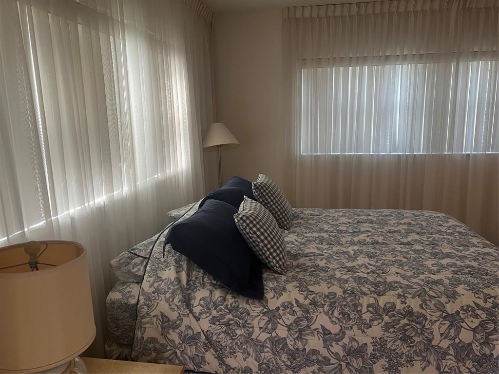 1425 Atlantic Shores Boulevard, Unit 601 Hallandale Beach, FL 33009 - Photo 14 of 23 a bedroom with a bed and a window
