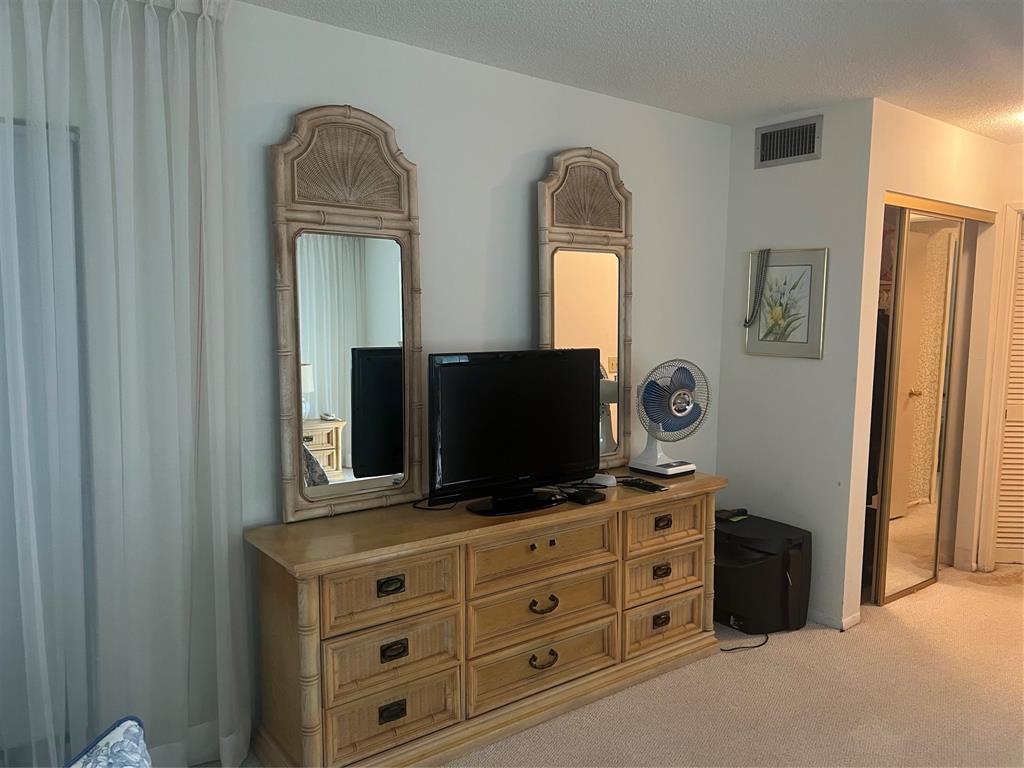 1425 Atlantic Shores Boulevard, Unit 601 Hallandale Beach, FL 33009 - Photo 15 of 23 a living room with furniture and a flat screen tv