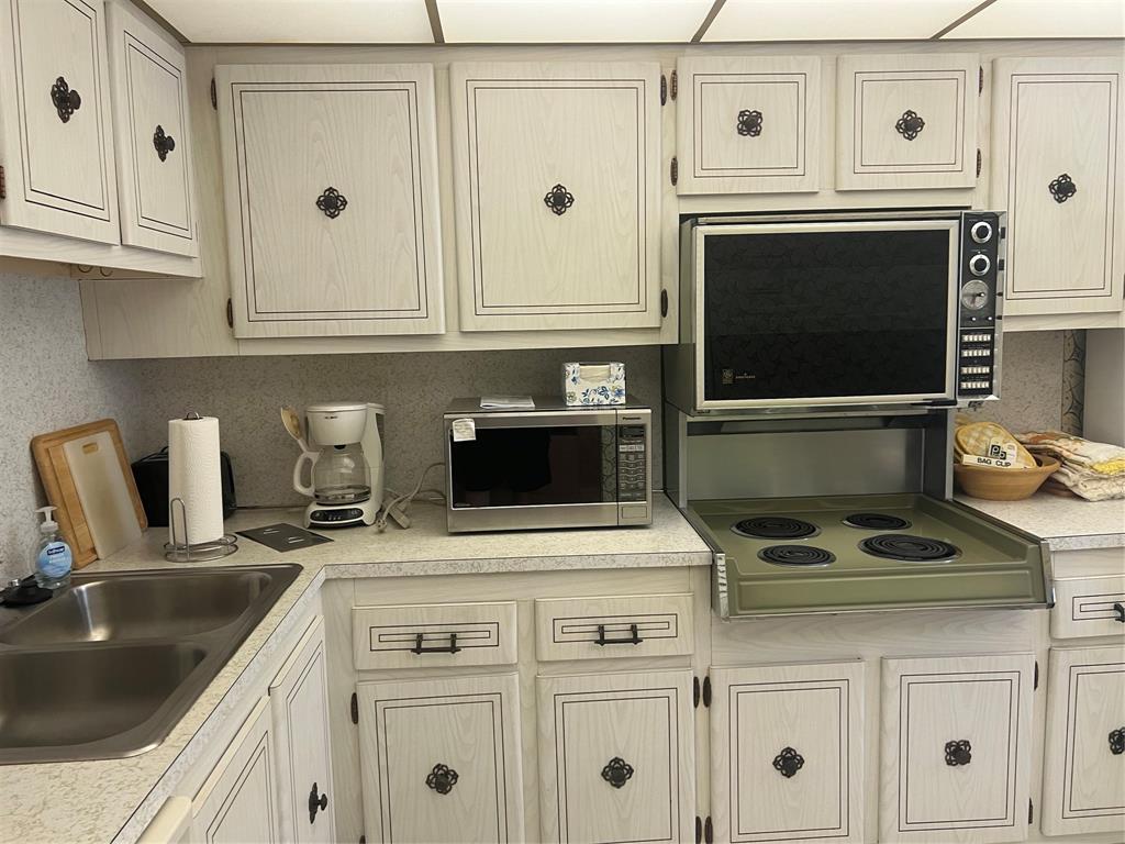 1425 Atlantic Shores Boulevard, Unit 601 Hallandale Beach, FL 33009 - Photo 3 of 23 a kitchen with granite countertop white cabinets and white stove
