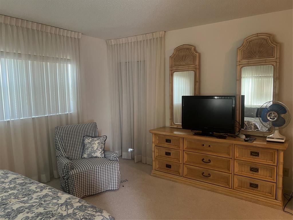 1425 Atlantic Shores Boulevard, Unit 601 Hallandale Beach, FL 33009 - Photo 8 of 23 a living room with furniture and flat screen tv