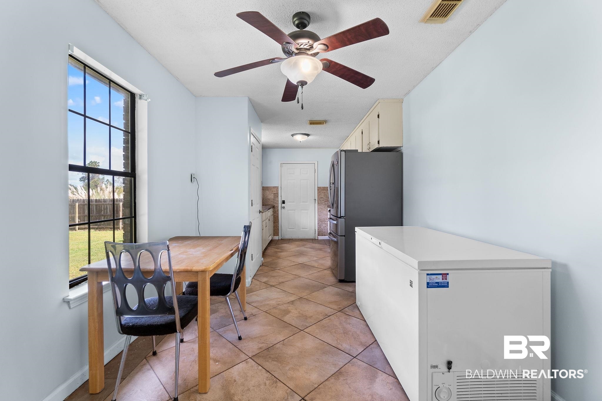 33135 Collier Road Lillian, AL 36549 - Photo 8 of 30 Dining area featuring light tile patterned floors and a ceiling fan