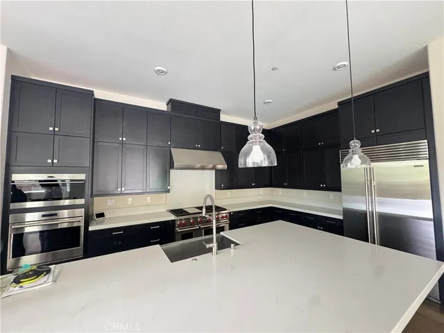 a kitchen with stainless steel appliances a refrigerator and a sink
