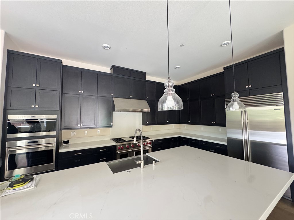 114 Crossover Irvine, CA 92618 - Photo 14 of 41 a kitchen with stainless steel appliances a refrigerator and a sink